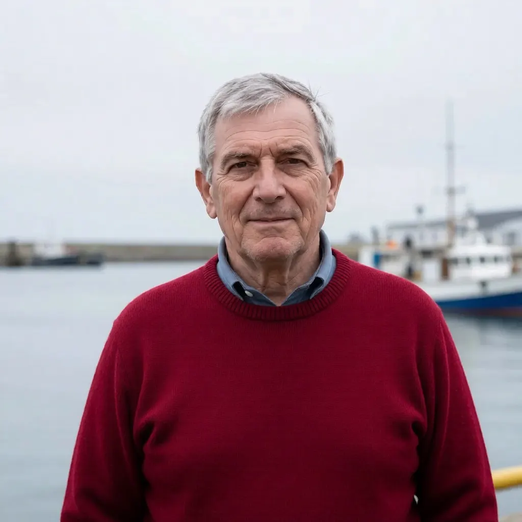 The same man at the same harbour wearing a deep red wool sweater instead of the grey one