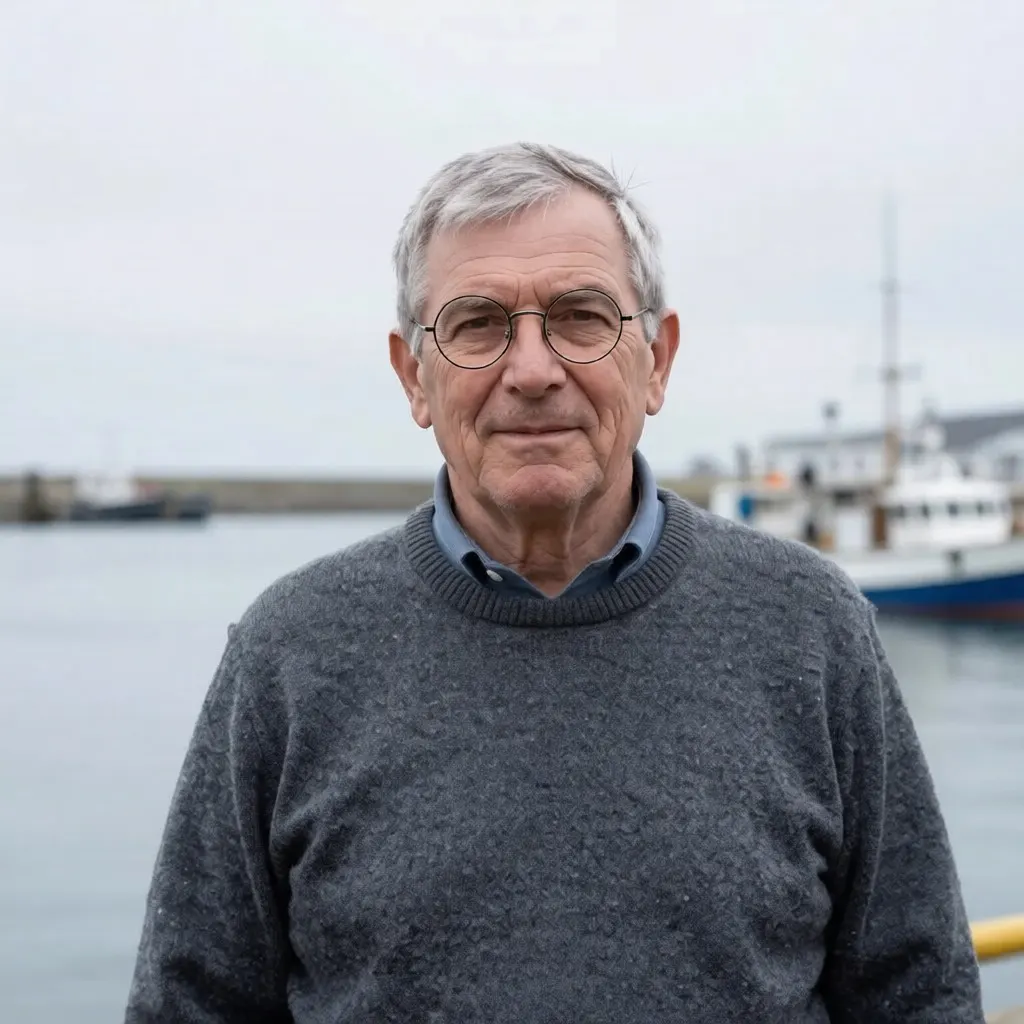 The same man wearing round wire-rimmed glasses, with a visibly coarser knit on the sweater